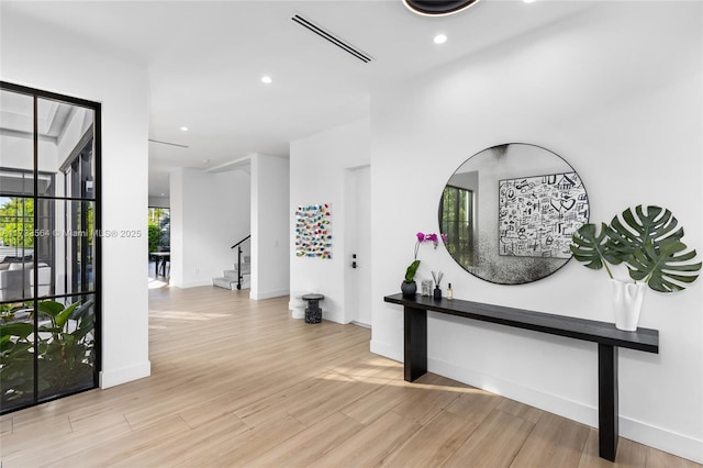 corridor with light hardwood / wood-style flooring