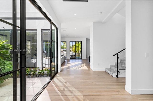 foyer featuring french doors and light hardwood / wood-style floors