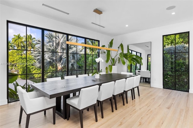 dining space with plenty of natural light and light wood-type flooring