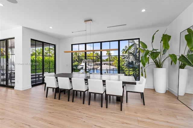 dining area featuring plenty of natural light and light wood-type flooring