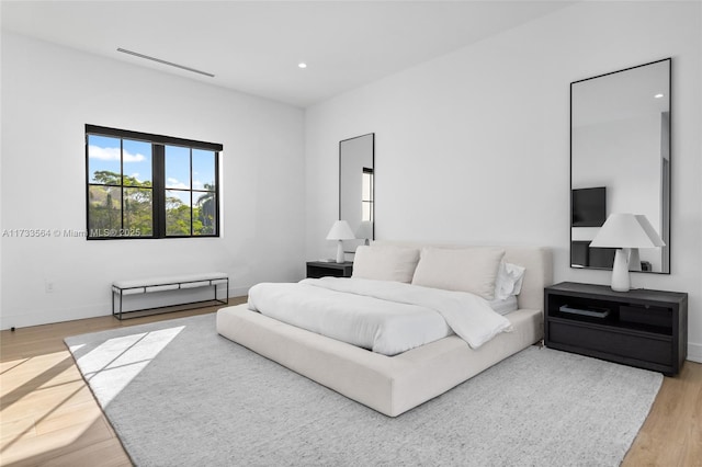 bedroom with wood-type flooring