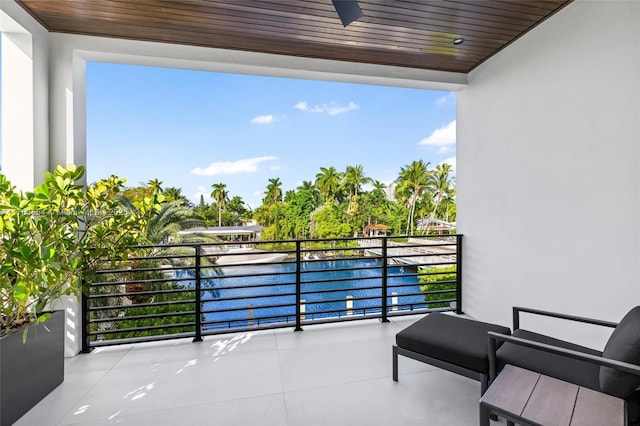 balcony with a water view and ceiling fan