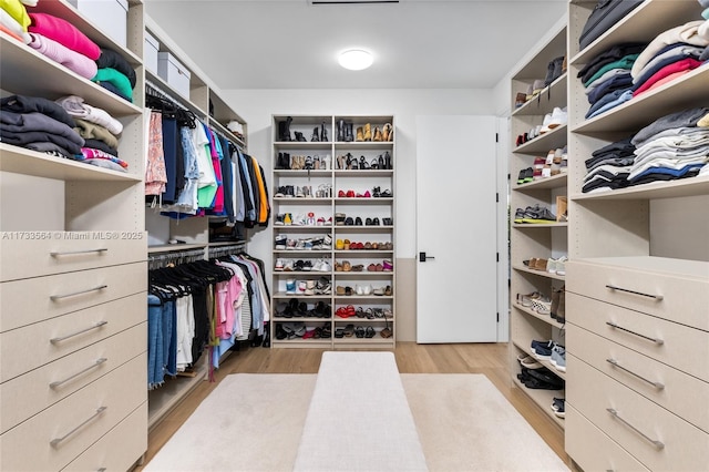 spacious closet featuring light wood-type flooring