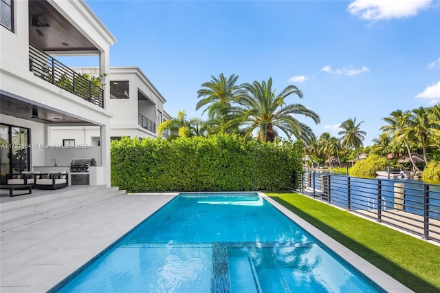 view of swimming pool featuring area for grilling, grilling area, and a patio