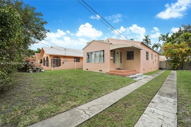 bungalow-style home with a front yard