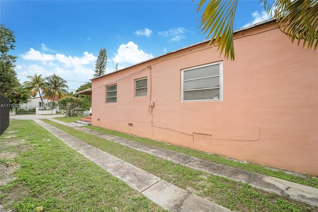 view of side of property with a lawn