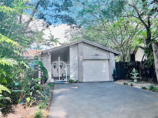 garage with driveway and fence