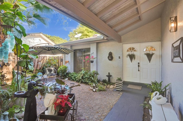 doorway to property featuring stucco siding