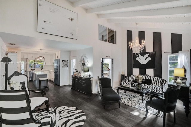 living room featuring a wealth of natural light, dark wood-style flooring, visible vents, and an inviting chandelier