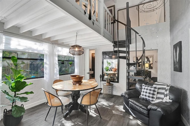 dining area with stairs, baseboards, wood finished floors, and beamed ceiling