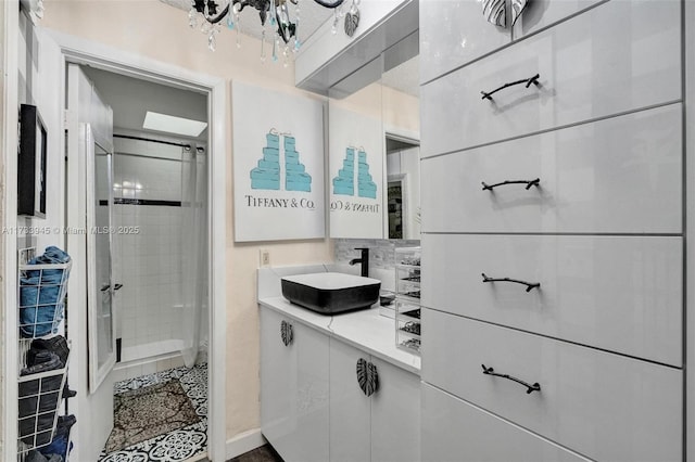 bathroom featuring a stall shower and vanity