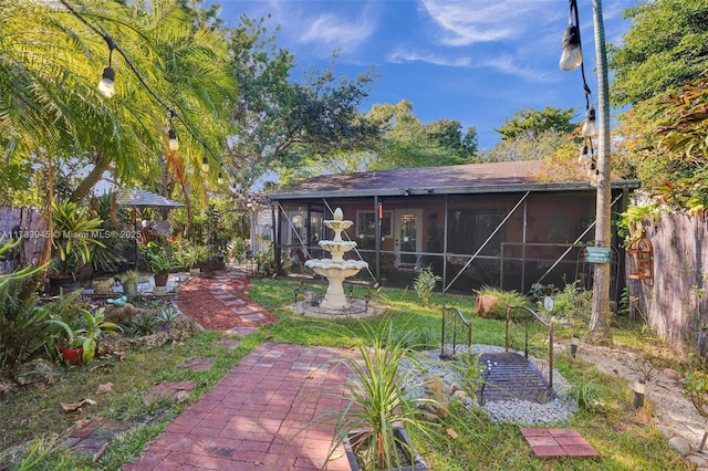 view of yard featuring a sunroom