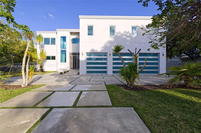 modern home with a garage and a front yard