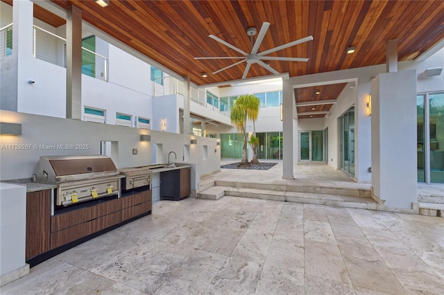 view of patio featuring area for grilling, sink, ceiling fan, and exterior kitchen