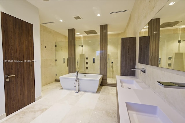 bathroom with tile walls, vanity, and plus walk in shower