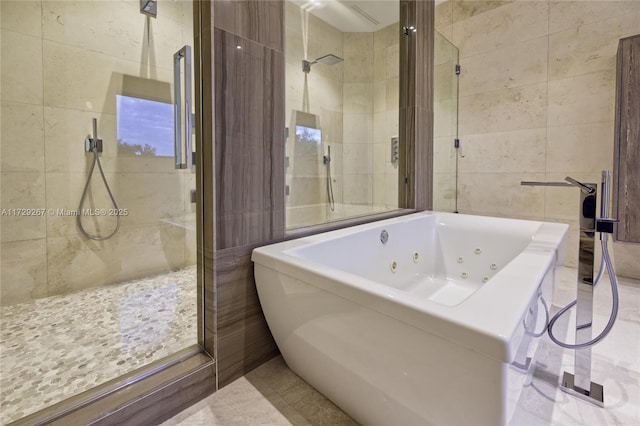 bathroom featuring independent shower and bath and tile walls