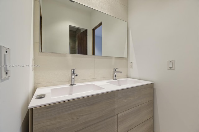 bathroom featuring vanity and backsplash