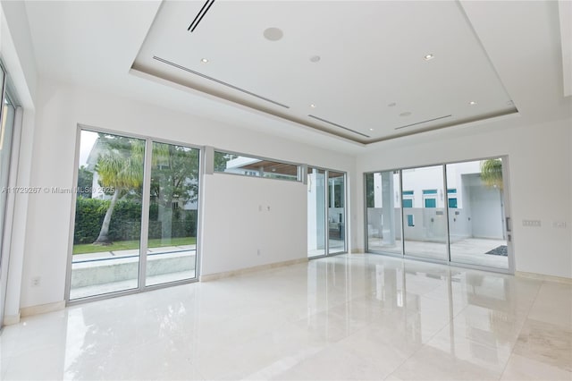 spare room with a tray ceiling