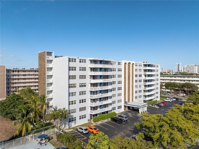 view of property featuring a view of city and uncovered parking