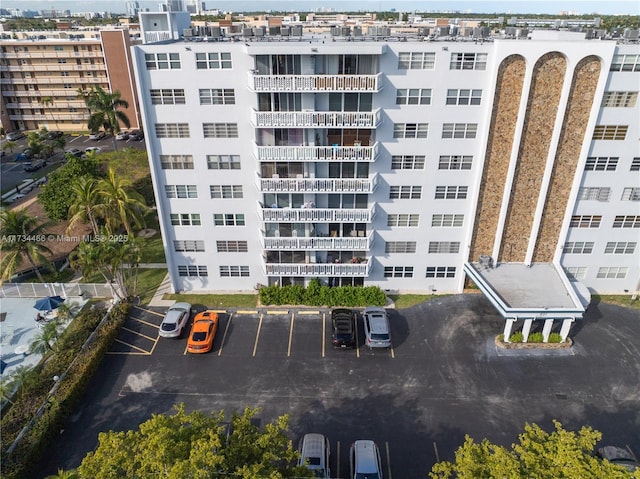 view of building exterior with uncovered parking