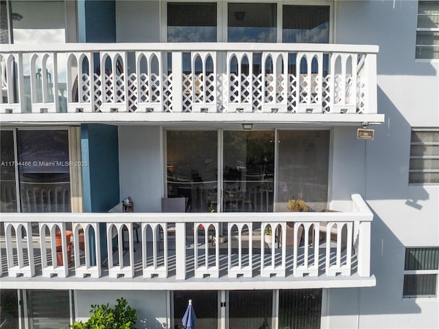 exterior space with a balcony and stucco siding