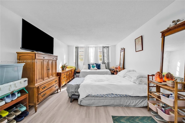 bedroom featuring a textured ceiling and wood finished floors