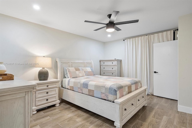 bedroom with ceiling fan and light hardwood / wood-style floors