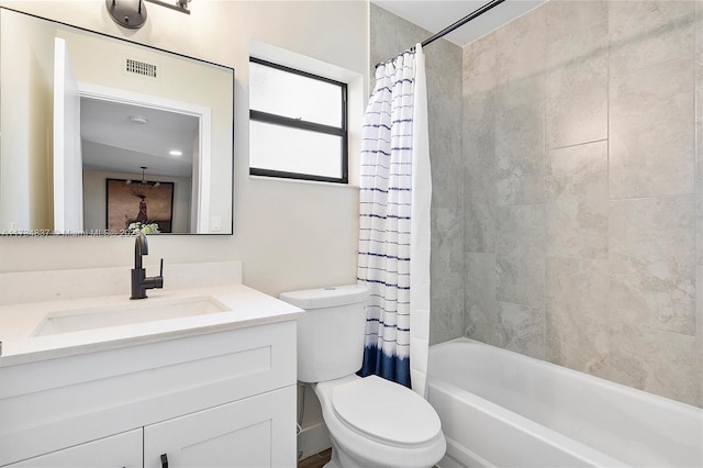 full bathroom with vanity, shower / bath combination with curtain, and toilet