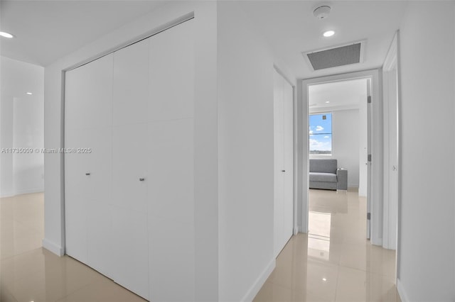 hall featuring light tile patterned floors