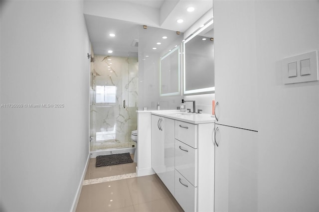 bathroom featuring a shower with door, vanity, tile patterned flooring, and toilet