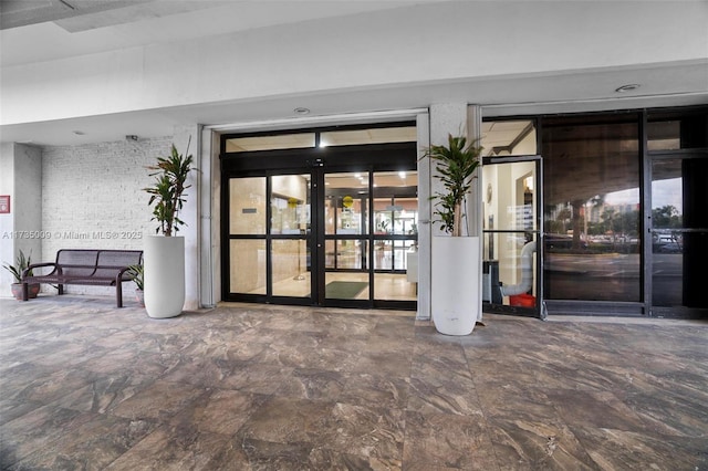 property entrance featuring a patio area and french doors