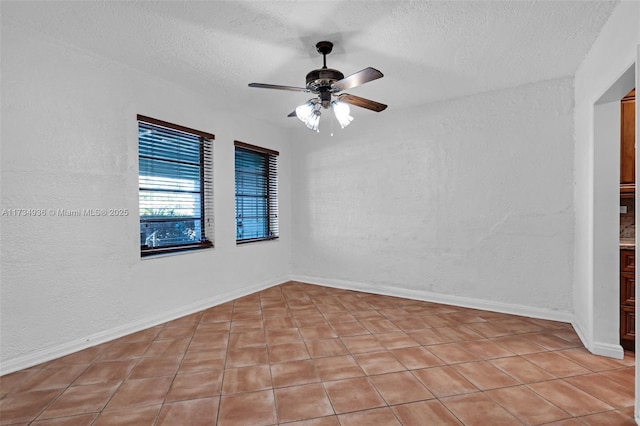 spare room featuring a textured ceiling and ceiling fan