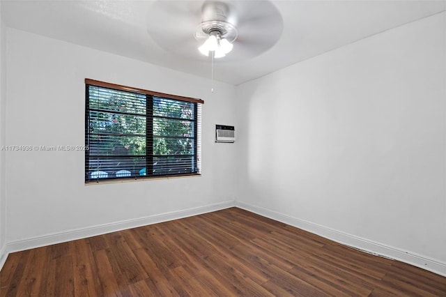 spare room with hardwood / wood-style floors, a wall mounted air conditioner, and ceiling fan