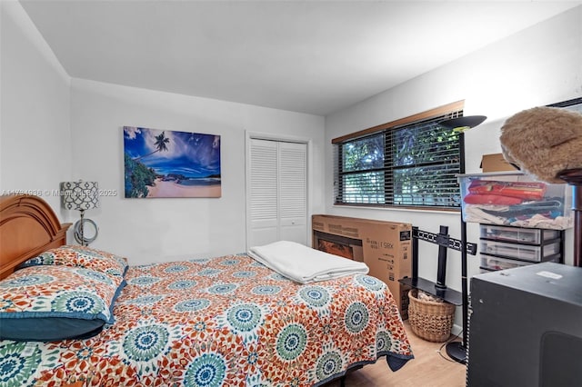 bedroom featuring light hardwood / wood-style floors and a closet