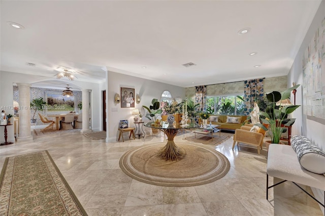 living room featuring ornamental molding and decorative columns