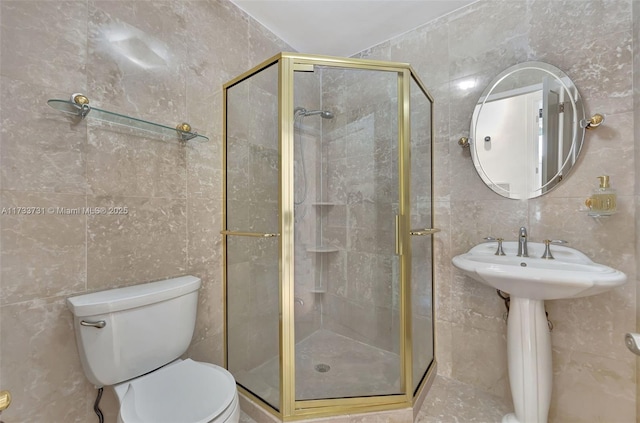 bathroom with tile walls, a shower with door, and toilet