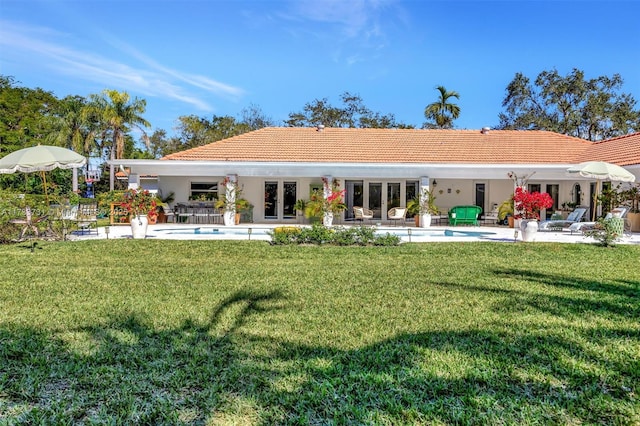 back of house with french doors, a yard, and a patio