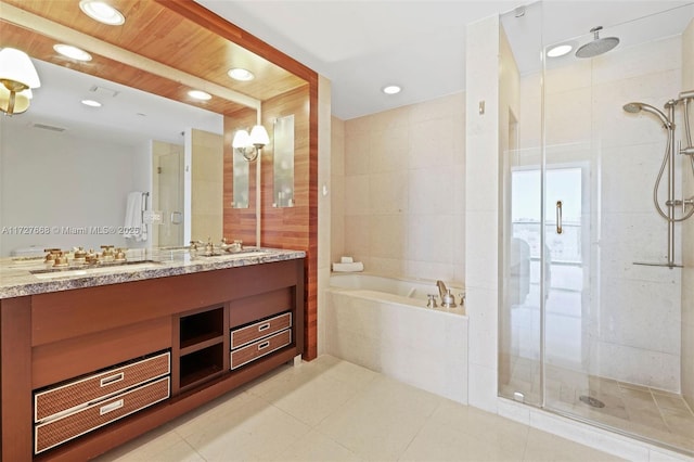 bathroom with vanity and shower with separate bathtub