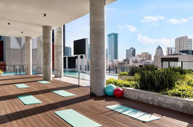 workout room featuring a wall of windows, light hardwood / wood-style floors, and a wealth of natural light