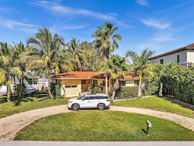 mediterranean / spanish house with a garage and a front yard