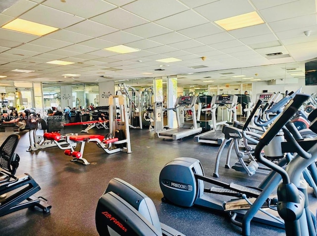 gym with a drop ceiling and french doors