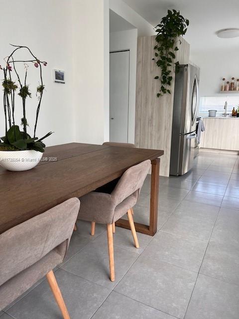 unfurnished dining area featuring light tile patterned flooring