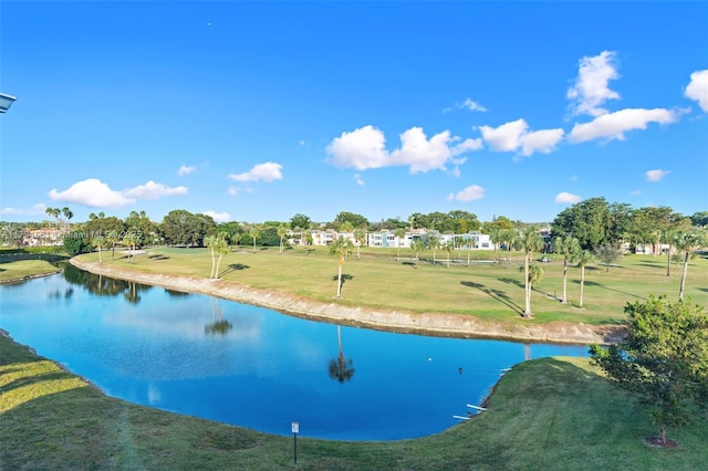 view of swimming pool featuring a water view and a yard