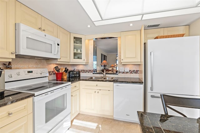 kitchen with white appliances, sink, decorative backsplash, and light tile patterned floors