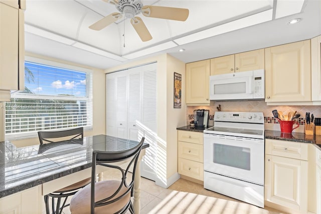 kitchen featuring white appliances, ceiling fan, cream cabinets, light tile patterned flooring, and decorative backsplash