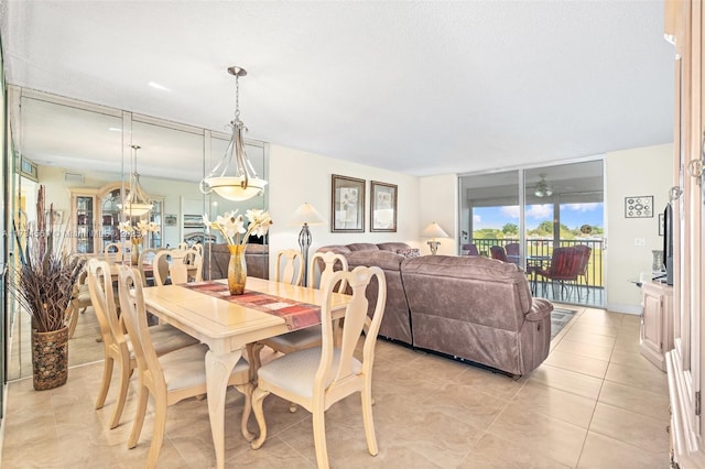 dining space featuring light tile patterned floors and a textured ceiling