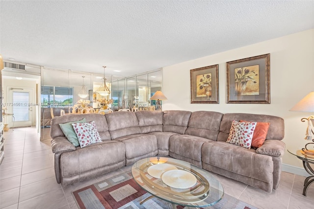 living room featuring light tile patterned flooring and a textured ceiling