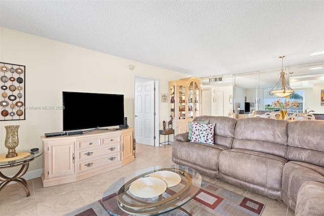 living room featuring a textured ceiling and light tile patterned flooring