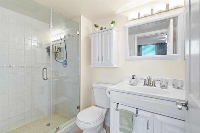 bathroom featuring vanity, toilet, and a shower with door