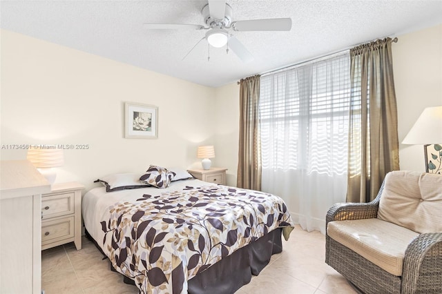 bedroom featuring ceiling fan, a textured ceiling, and light tile patterned floors